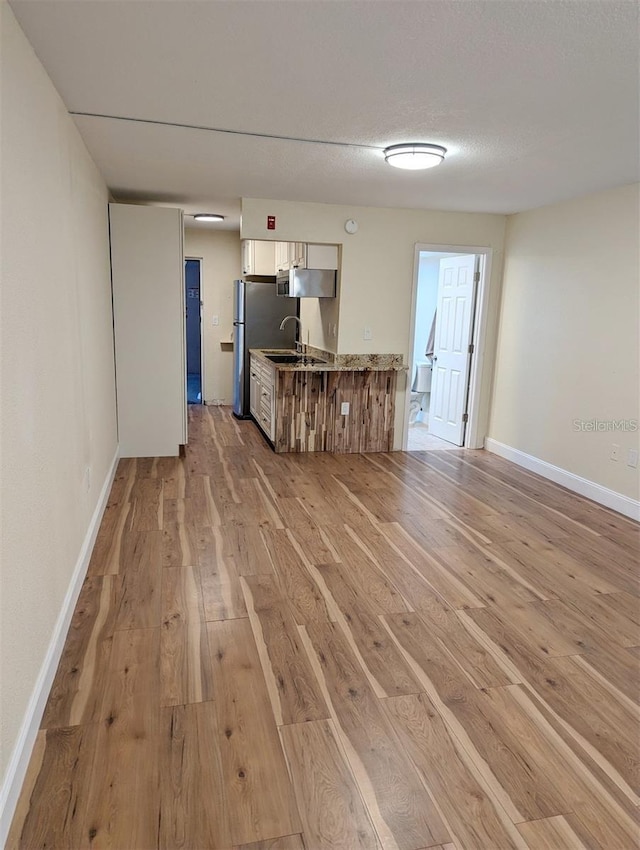 unfurnished living room with light hardwood / wood-style floors