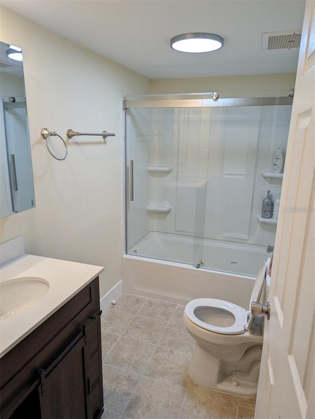 full bathroom featuring vanity, toilet, tile patterned flooring, and combined bath / shower with glass door