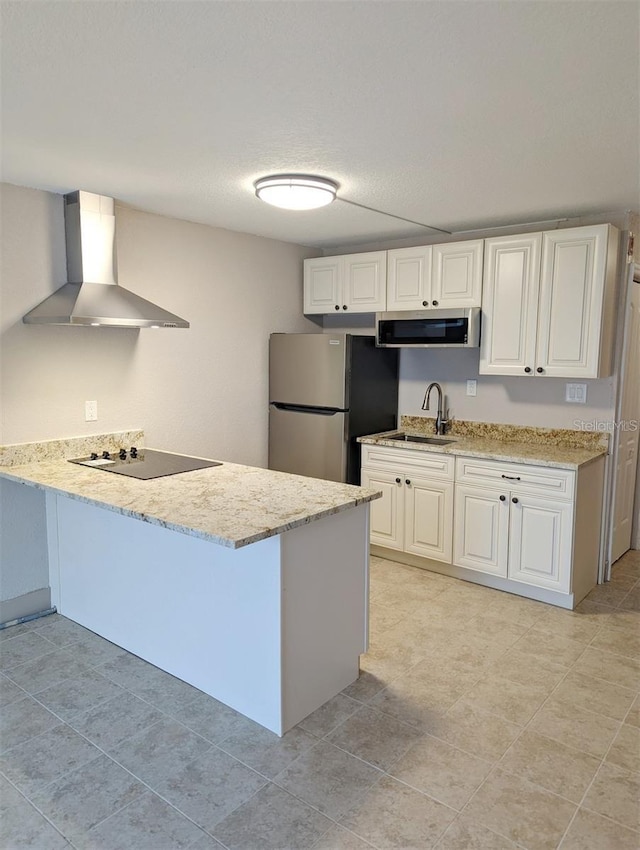 kitchen with sink, white cabinetry, stainless steel appliances, kitchen peninsula, and wall chimney exhaust hood