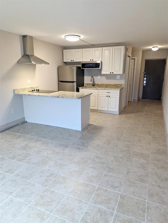 kitchen with stainless steel appliances, white cabinetry, wall chimney range hood, and kitchen peninsula