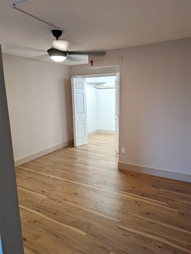 unfurnished room featuring hardwood / wood-style flooring, a textured ceiling, and ceiling fan