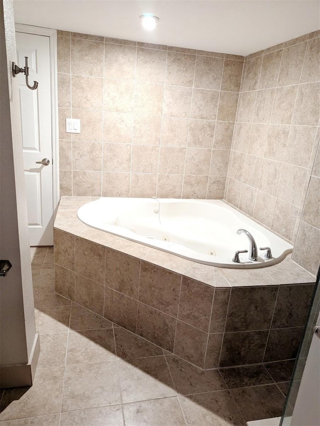 bathroom featuring tile patterned floors and tiled bath