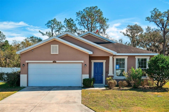 view of front of property featuring a garage and a front yard