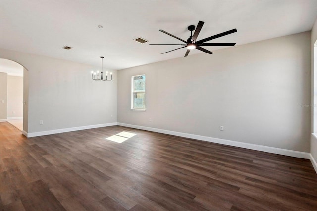 unfurnished room with dark hardwood / wood-style flooring and ceiling fan with notable chandelier