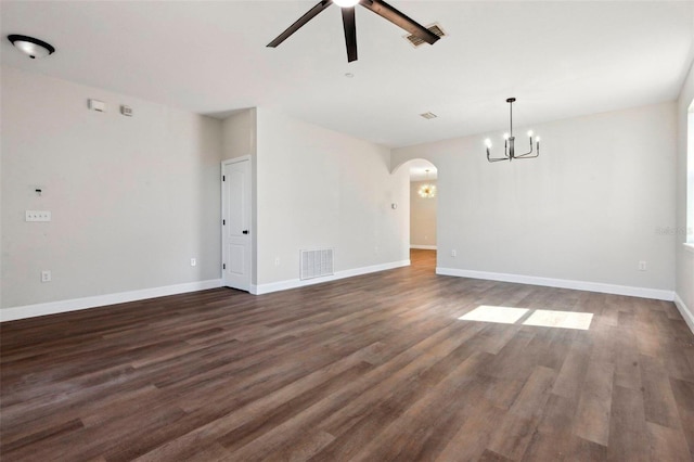 unfurnished room with dark hardwood / wood-style floors and ceiling fan with notable chandelier