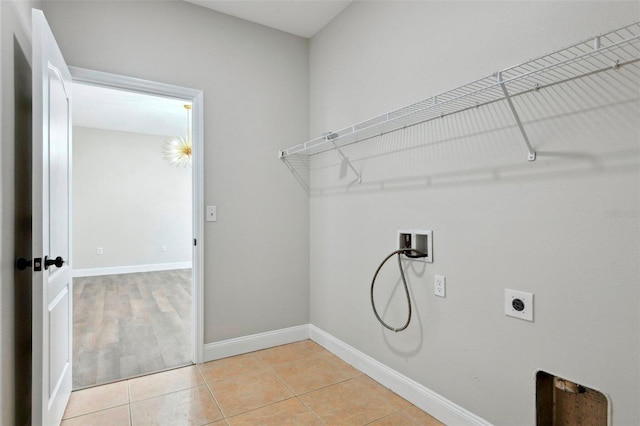 laundry room featuring washer hookup, light tile patterned floors, and electric dryer hookup