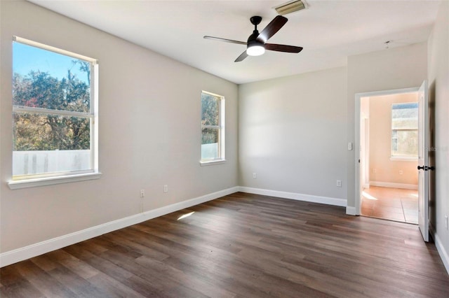 spare room featuring ceiling fan and dark hardwood / wood-style floors