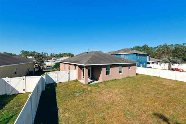 back of property featuring a lawn