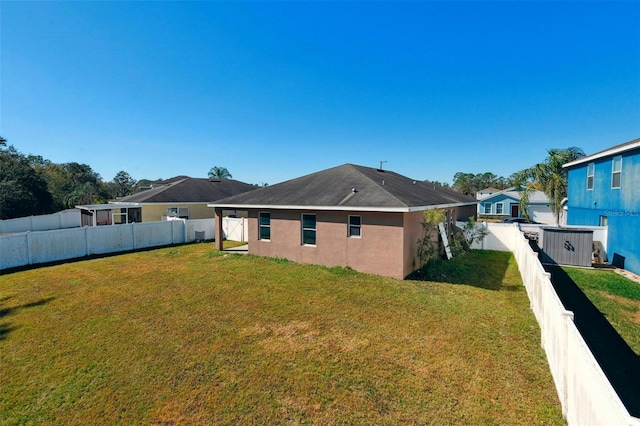 back of house with a lawn