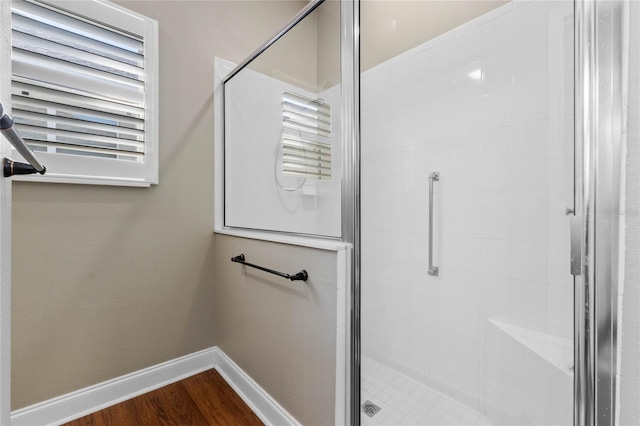 bathroom with an enclosed shower and wood-type flooring