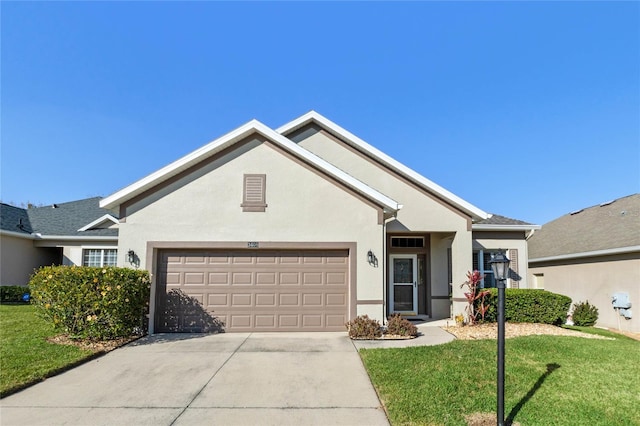 view of front of home with a garage and a front lawn