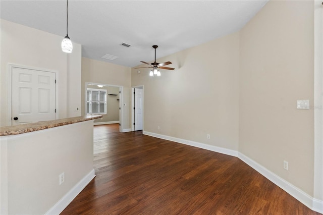 unfurnished living room featuring ceiling fan and dark hardwood / wood-style floors