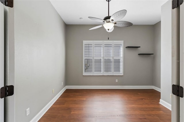 unfurnished room featuring dark wood-type flooring and ceiling fan