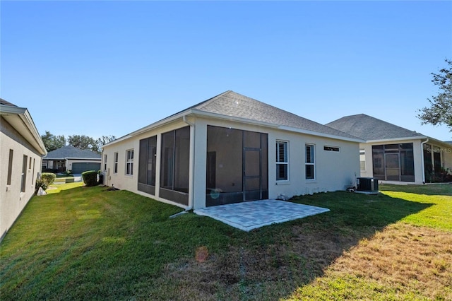 rear view of property featuring cooling unit, a yard, a sunroom, and a patio