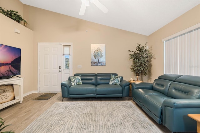 living room with lofted ceiling, hardwood / wood-style floors, and ceiling fan