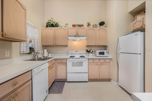 kitchen with white appliances, sink, and light brown cabinets