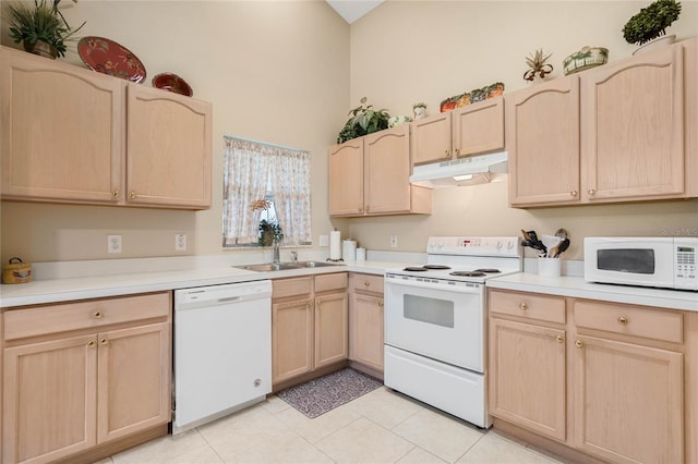 kitchen with white appliances, light tile patterned floors, sink, and light brown cabinets