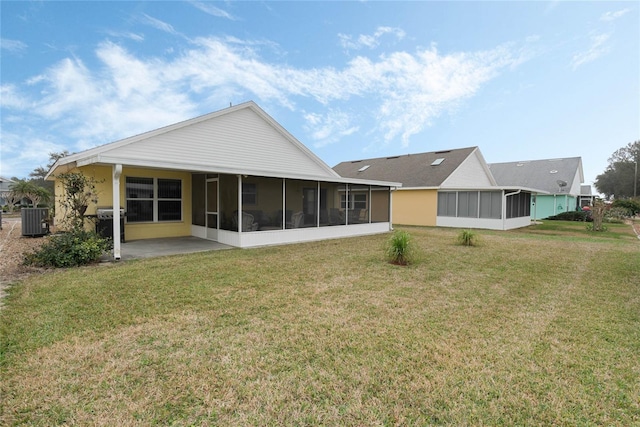 rear view of property with cooling unit, a patio, a yard, and a sunroom