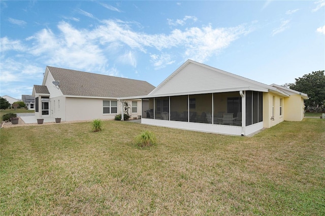 back of house with a yard and a sunroom