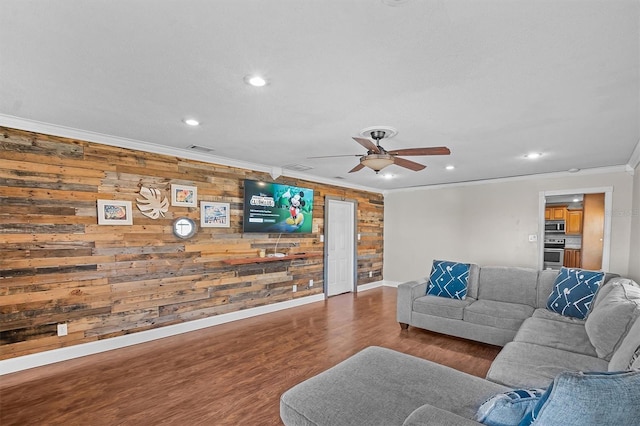 living room featuring wood-type flooring, ornamental molding, and ceiling fan