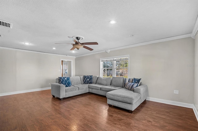 living room featuring dark hardwood / wood-style flooring, ceiling fan, crown molding, and a textured ceiling