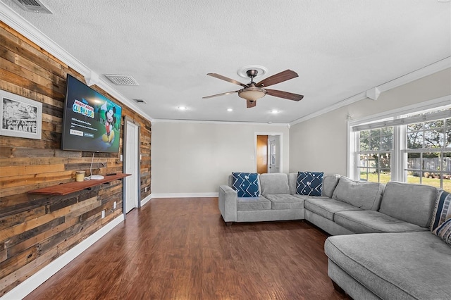 living room with crown molding, ceiling fan, a textured ceiling, and dark hardwood / wood-style flooring