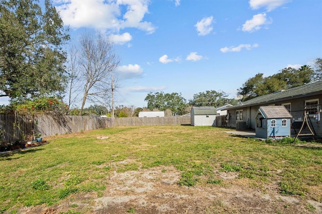 view of yard featuring a shed and central air condition unit