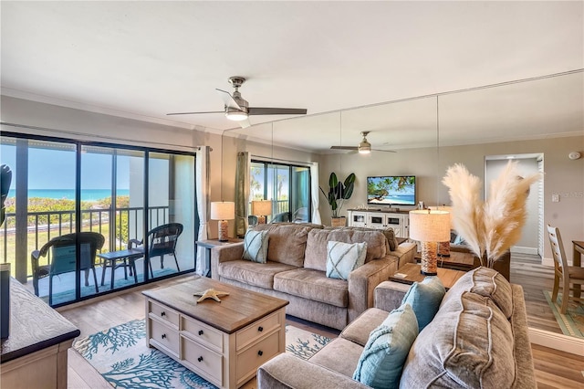 living room with ceiling fan, ornamental molding, and light hardwood / wood-style floors