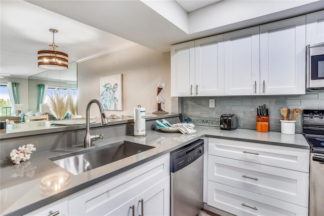 kitchen featuring sink, decorative backsplash, stainless steel appliances, and white cabinets