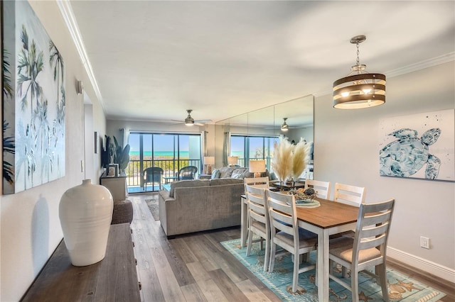 dining area featuring crown molding, hardwood / wood-style flooring, and ceiling fan