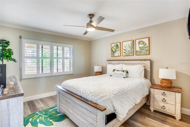 bedroom featuring crown molding, ceiling fan, and dark hardwood / wood-style floors