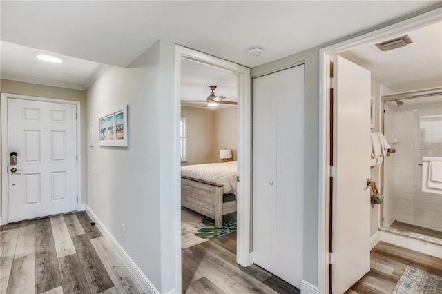 hallway with hardwood / wood-style flooring