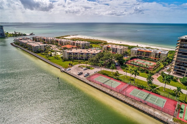 birds eye view of property with a beach view and a water view