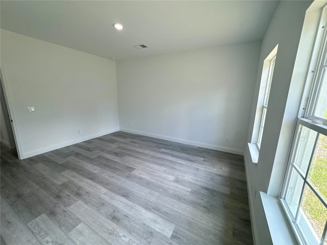 empty room featuring plenty of natural light and light hardwood / wood-style floors