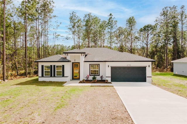 view of front of property with a garage and a front lawn