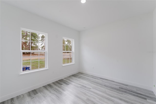 empty room featuring a healthy amount of sunlight and light wood-type flooring