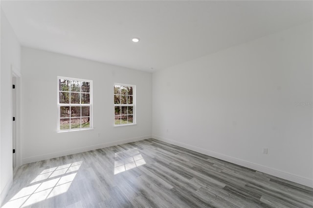 spare room with light hardwood / wood-style flooring