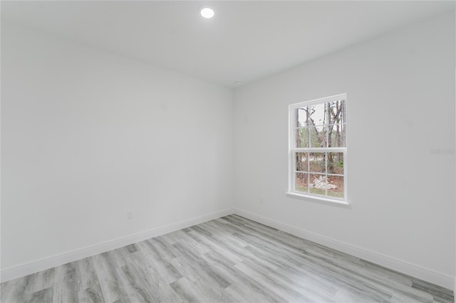 unfurnished room with light hardwood / wood-style floors