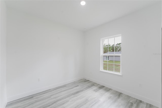 unfurnished room with light hardwood / wood-style floors