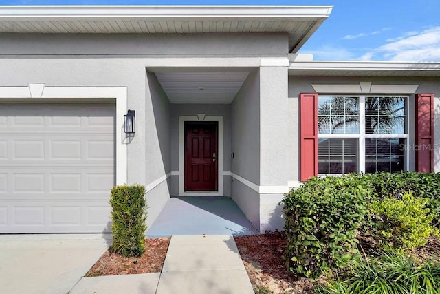 view of exterior entry with a garage