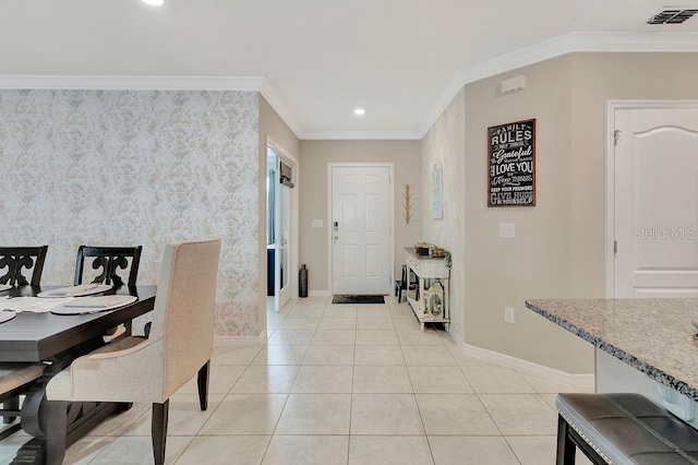 tiled foyer entrance featuring ornamental molding