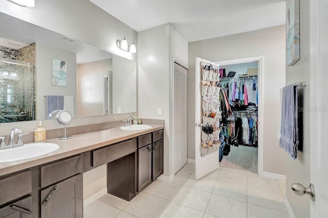 bathroom featuring an enclosed shower, vanity, and tile patterned floors