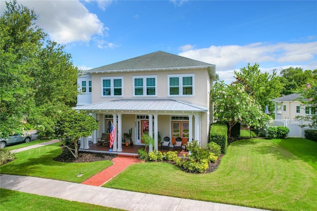 view of front of home with a porch and a front yard