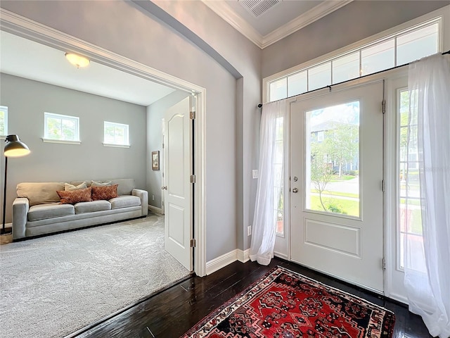 foyer entrance featuring ornamental molding, dark hardwood / wood-style floors, and a healthy amount of sunlight