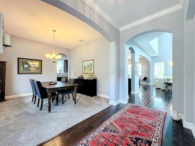 dining space featuring ornamental molding, vaulted ceiling, dark wood-type flooring, and a chandelier