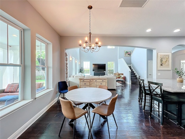 dining area featuring an inviting chandelier and dark hardwood / wood-style floors