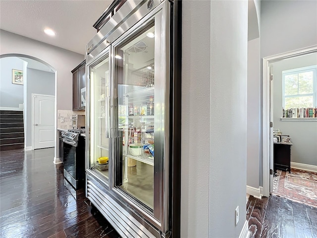 hallway with dark hardwood / wood-style flooring