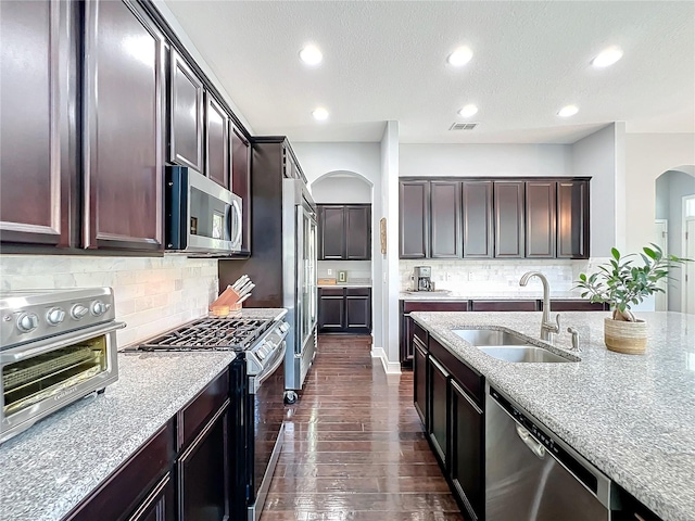 kitchen featuring dark hardwood / wood-style flooring, sink, dark brown cabinets, and stainless steel appliances