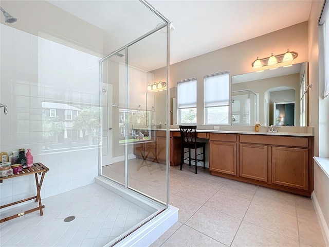 bathroom featuring vanity, tile patterned floors, and walk in shower