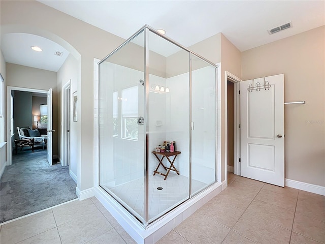 bathroom with tile patterned flooring and an enclosed shower